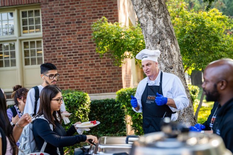 Eberhardt School of Business students are treated to "pancakes with the dean" during Week of Welcome in 2023.
