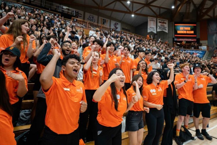 students cheer inside the Alex G. Spanos Center