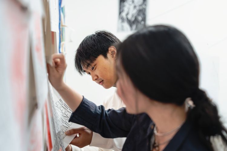 Students put the final touches on the Muse: Calliope 55 exhibition at Reynolds Gallery.