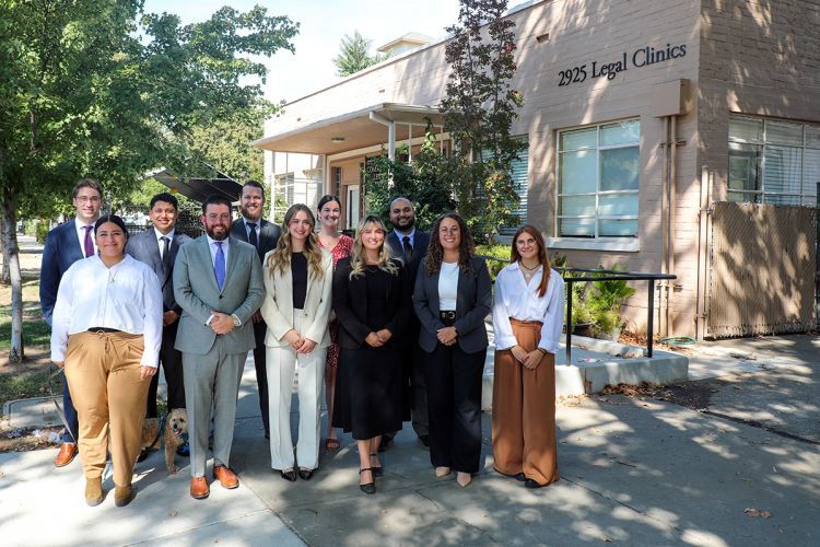 A group of people outside smiling 