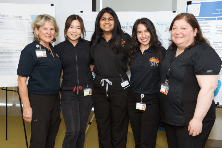 students and faculty member pose at Senior Smiles event
