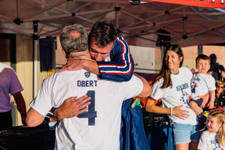 Alex Obert hugs a family member