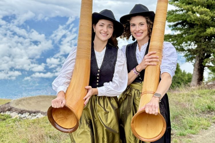 Conservatory student and professor holding alphorns