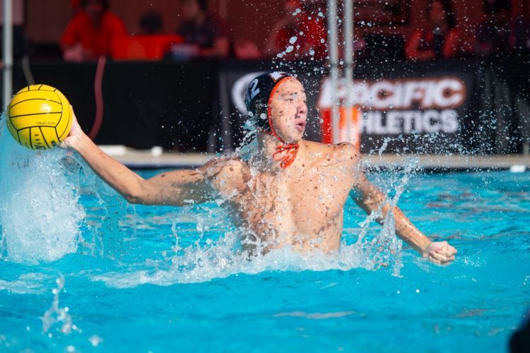 A waterpolo athlete throwing a ball in a pool