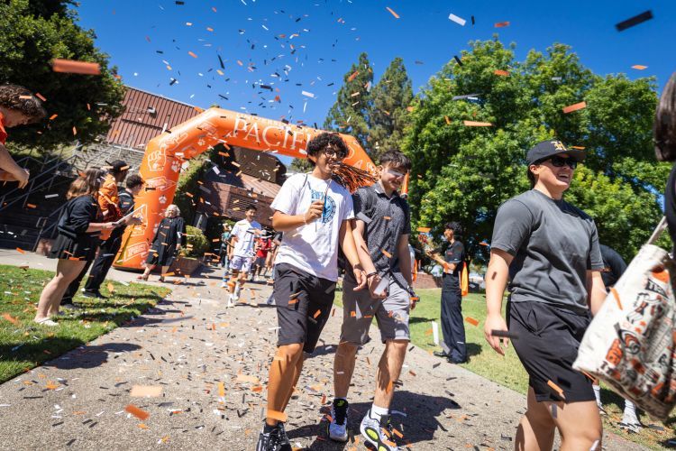 Pacific students at Tiger Roar walking through confetti 