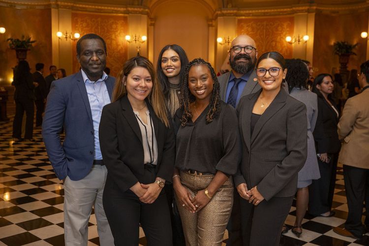 A group of individuals stand to pose for a photo. 