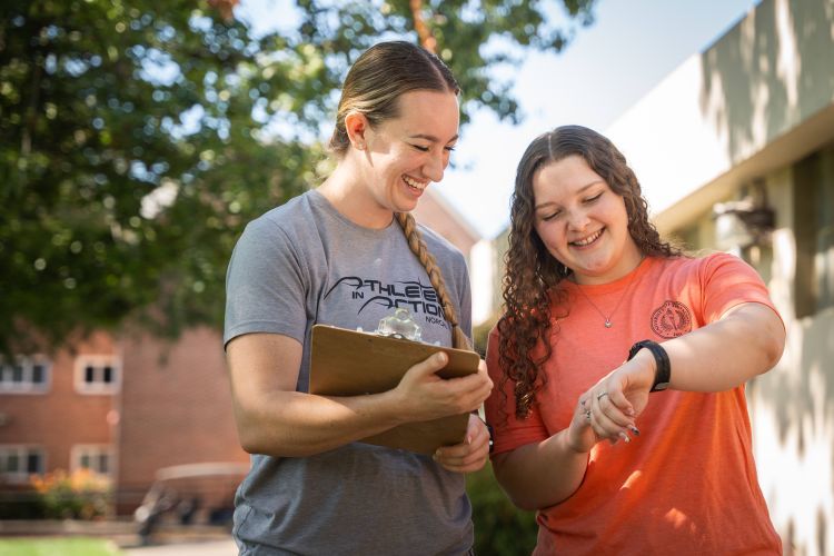 Two students looking at fitness tracker