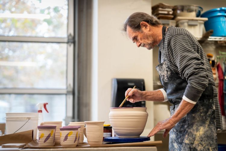 A man paints pottery