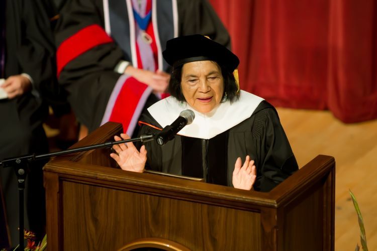 Dolores Huerta at a podium speaking.