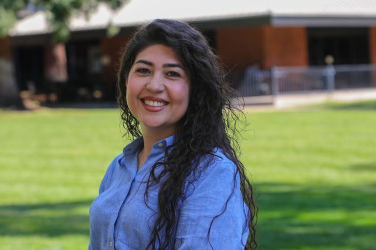 A women smiles for a picture. 