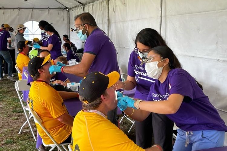 Healthy Smiles volunteers with athletes