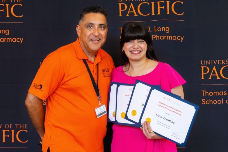 Associate Clinical Professor Rolly Kali-Rai with PharmD student