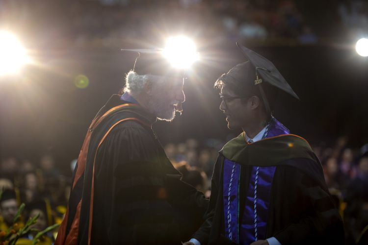 Professor Emeritus Eric Boyce with a PharmD graduate at Commencement