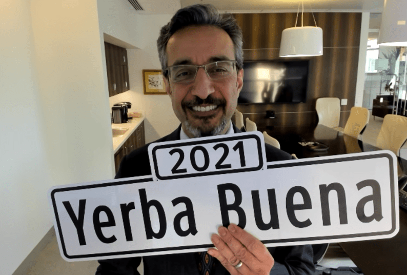 Dean Nadershahi holding up a sign that says 2021 Yerba Buena
