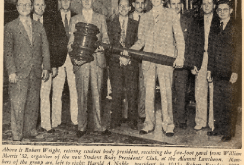 A group of officers of the Pacific Alumni Association hold a 5-foot gavel.