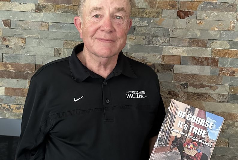 Jonathan Brown, holding a copy of his book