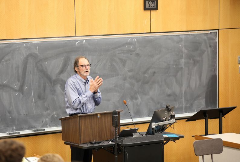 A professor stands at the front of a lecture hall at McGeorge School of Law teaching a class. 