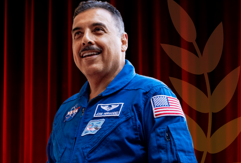 Jose smiles in a blue NASA uniform