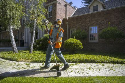 University of the Pacific employee Dillon Krieger uses an edger to trim the lawn on the Stockton Campus on Tuesday, July 14, 2020.