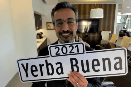 Dean Nadershahi holding up a sign that says 2021 Yerba Buena