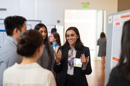 A student presents her research to other students