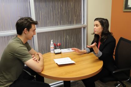 two people talking while sitting at a table