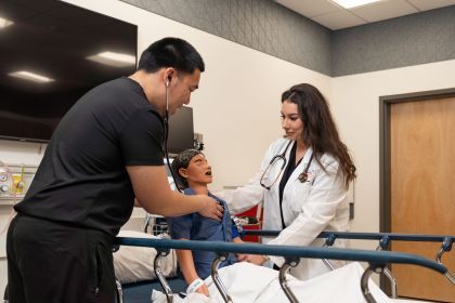 nursing students work with a mannequin in the clinical skills lab