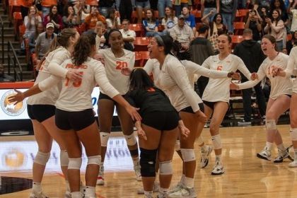 women's volleyball team celebrates on the court