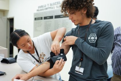 students practice using a blood pressure cuff