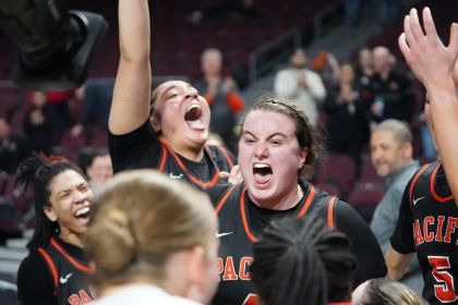 women's team celebrates their win on the court