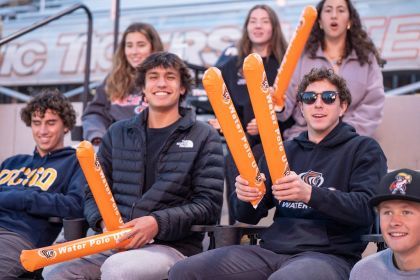 fans sit in the stands of a water polo game