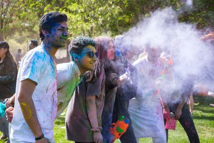 students pose for a photo at a holi event