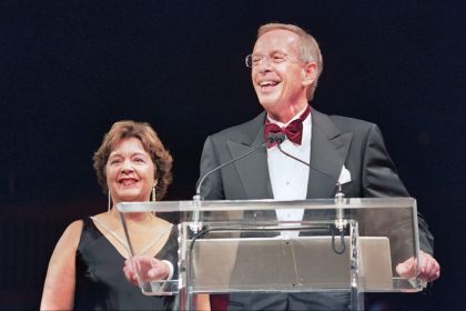 Robert H. Christoffersen stands at a podium with alumna Debra Finney '86 