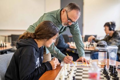 a student and instructor in the chess program