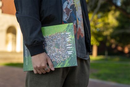 a student holds a copy of Pacific magazine