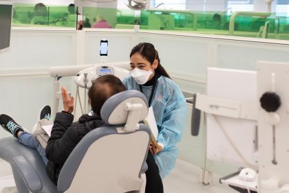 a dental student works with a patient