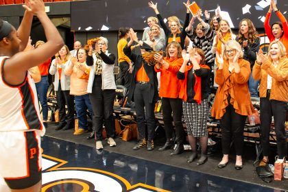 women cheer on the women's basketball team