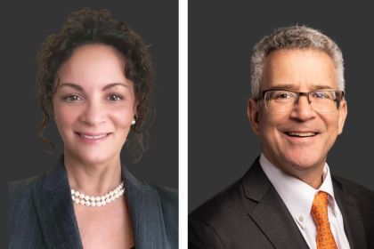 headshots of a woman and man in front of a grey background