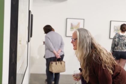 A woman looks at a watercolor painting at an exhibit inside University of the Pacific's Reynolds Gallery.