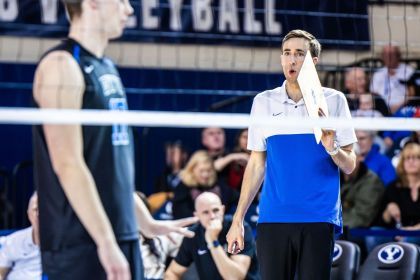 Devin Young coaches a player on the court