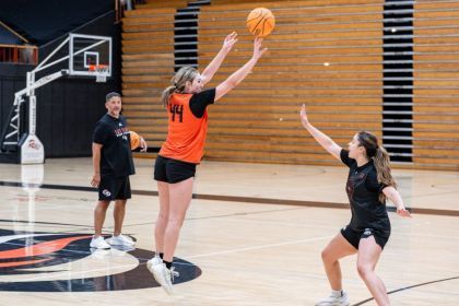 A student shoots a basketball.