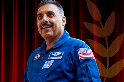 Jose smiles in a blue NASA uniform