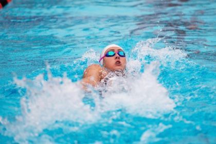 Macy Coad swims in the water 