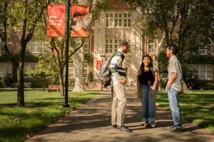 Students talking in a group outside of Knoles Hall.