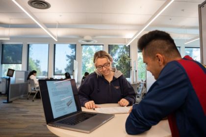 Two students studying in the library 