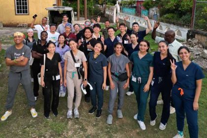25 men and women dressed in scrubs in Jamaica