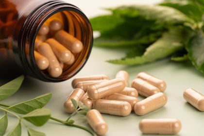 Homeopathic remedy capsules in a glass amber jar