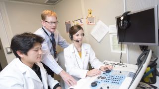 audiology professor and students in lab