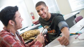 student using stethoscope on athlete