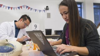 student in front of a laptop